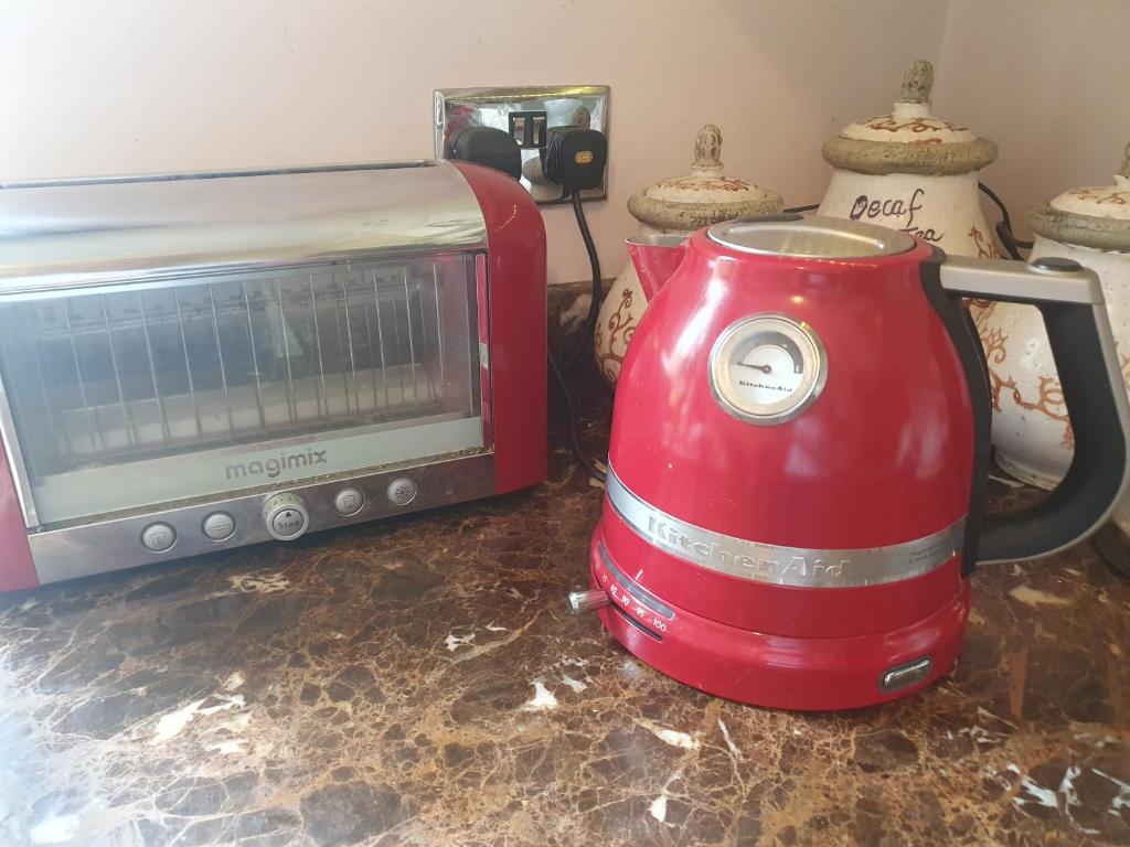 Magimix toaster and KitchenAid kettle on the worktop, with
                                      tea, coffee and decaf canisters behind.